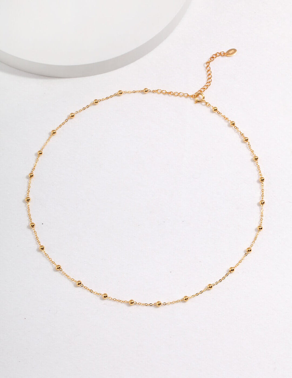 Gold necklace on a white background