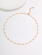Gold necklace on a white background