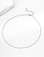 The minimalist bracelet and necklace set being worn together as an outfit.