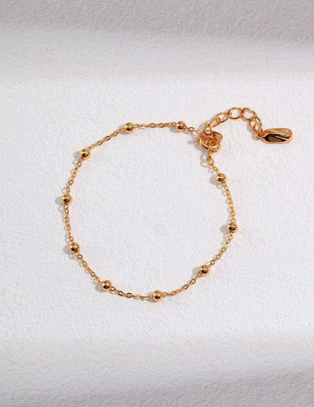 Close-up detail of the lobster clasps and extender chains on both pieces.