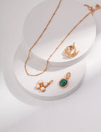 The set layered with other delicate necklaces and bracelets.