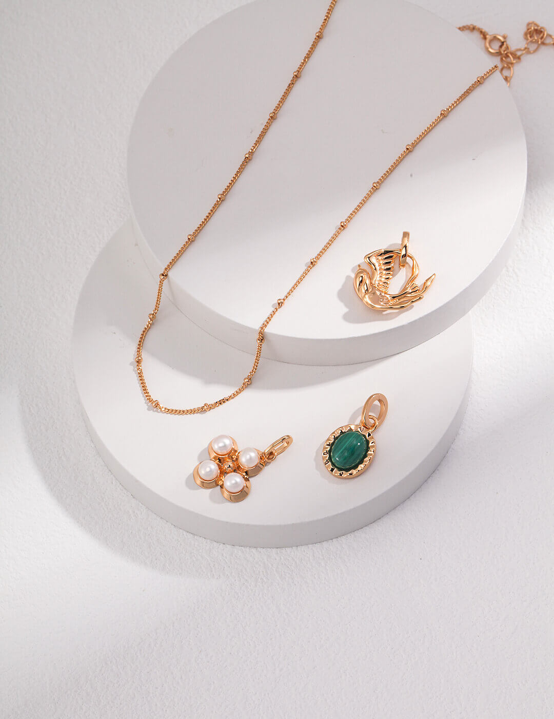 The set layered with other delicate necklaces and bracelets.