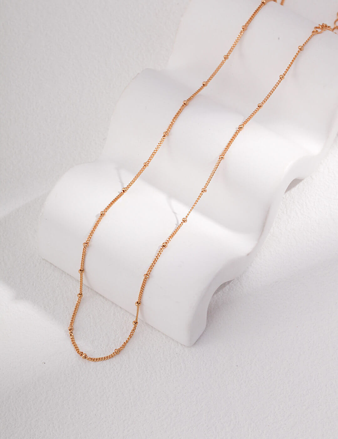 The jewelry set adding a subtle elegance to a casual everyday outfit.