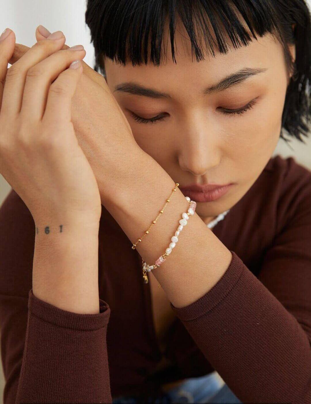 The bracelet and necklace set beautifully arranged inside an open gift box.
