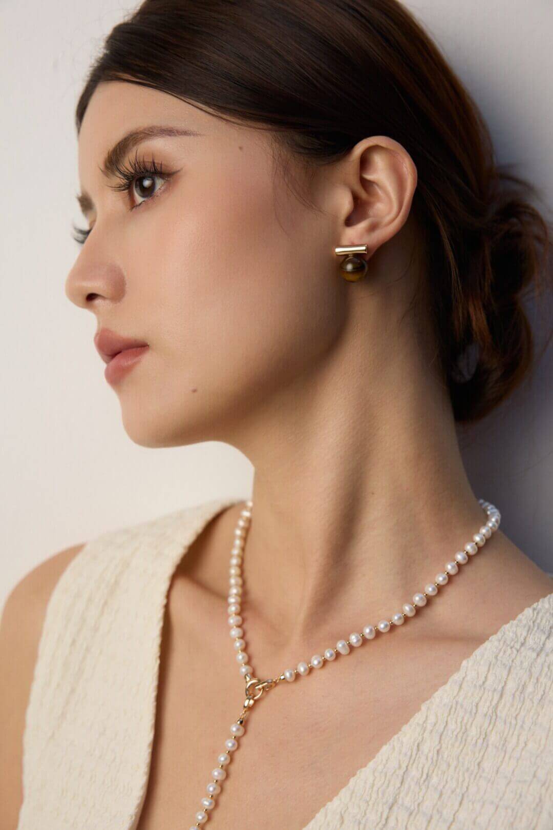 Side profile view of the studs sitting perfectly on the earlobe.