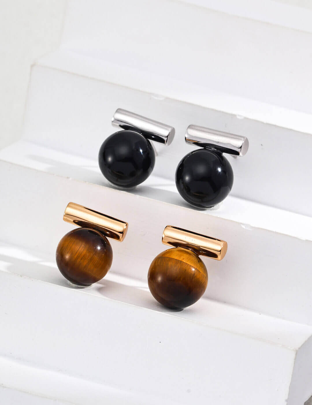 Size comparison showing the 1.7cm stud earrings next to a coin.