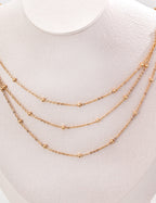 Gold necklace on a white mannequin bust