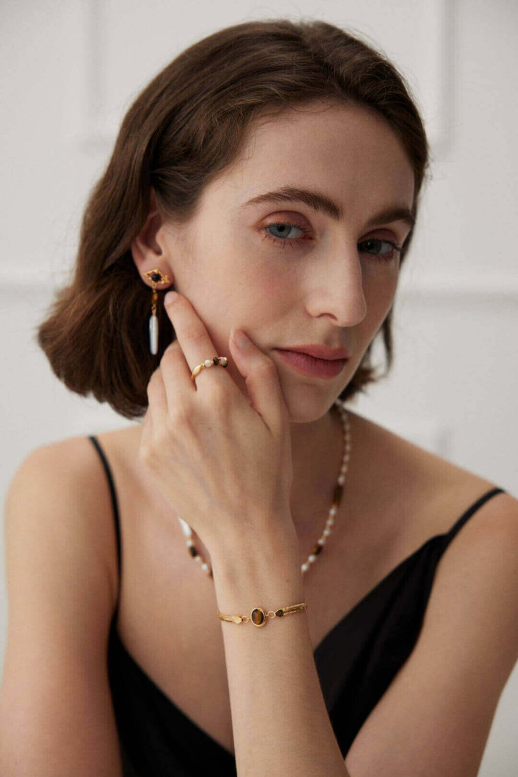 Closeup of bracelet on model's wrist in soft natural lighting conditions.