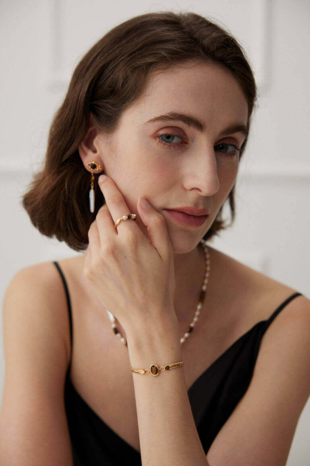 Closeup of bracelet on model's wrist in soft natural lighting conditions.