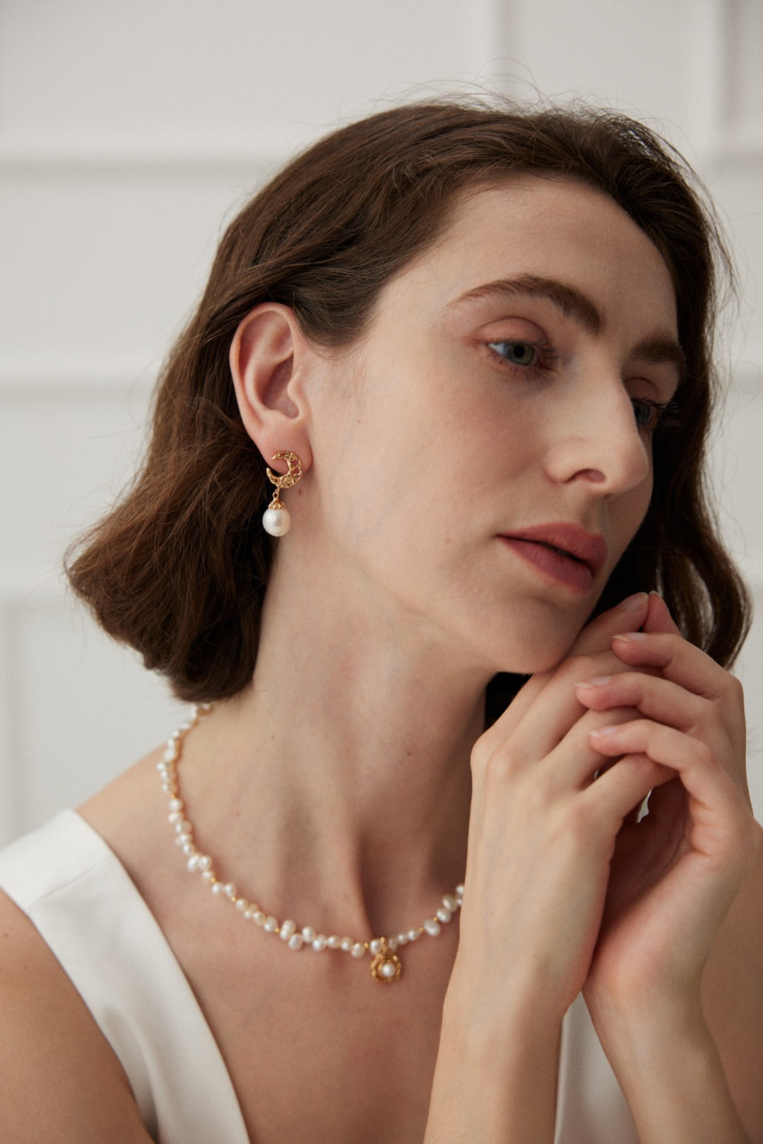 Casual daytime style featuring the camellia pendant necklace on a sweater.