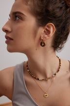 Model wearing one style on each ear, demonstrating the versatility.