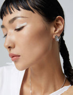 Asymmetric earrings in natural light showing color play