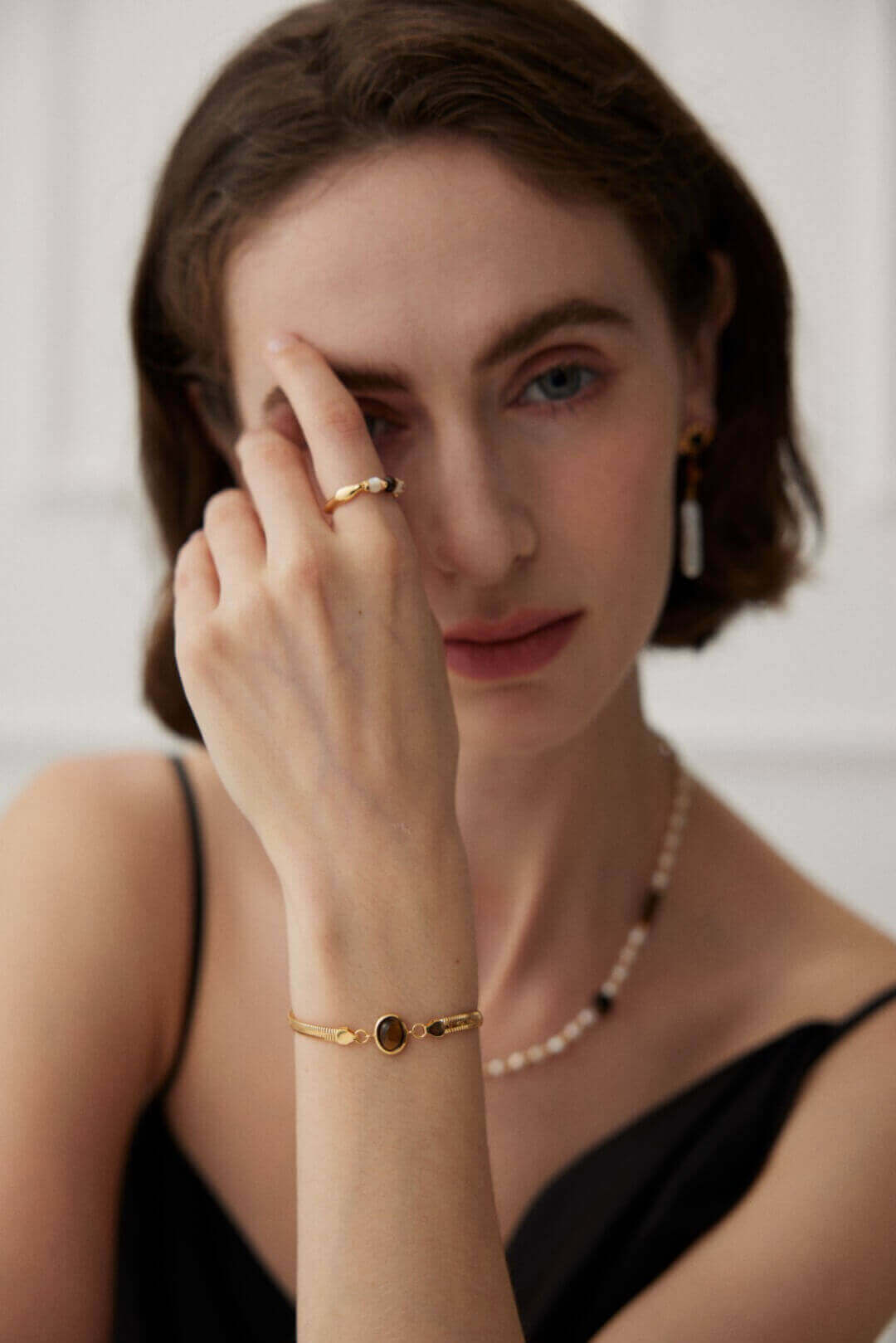 Female model wearing Lapis Lazuli and Tiger's Eye bracelet - wrist closeup shot.