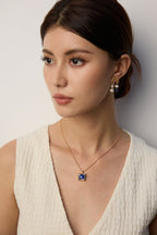 Woman wearing lapis lazuli pendant necklace with casual daytime attire.