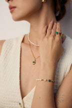 The bracelet stacked with other gold bracelets for a layered look.