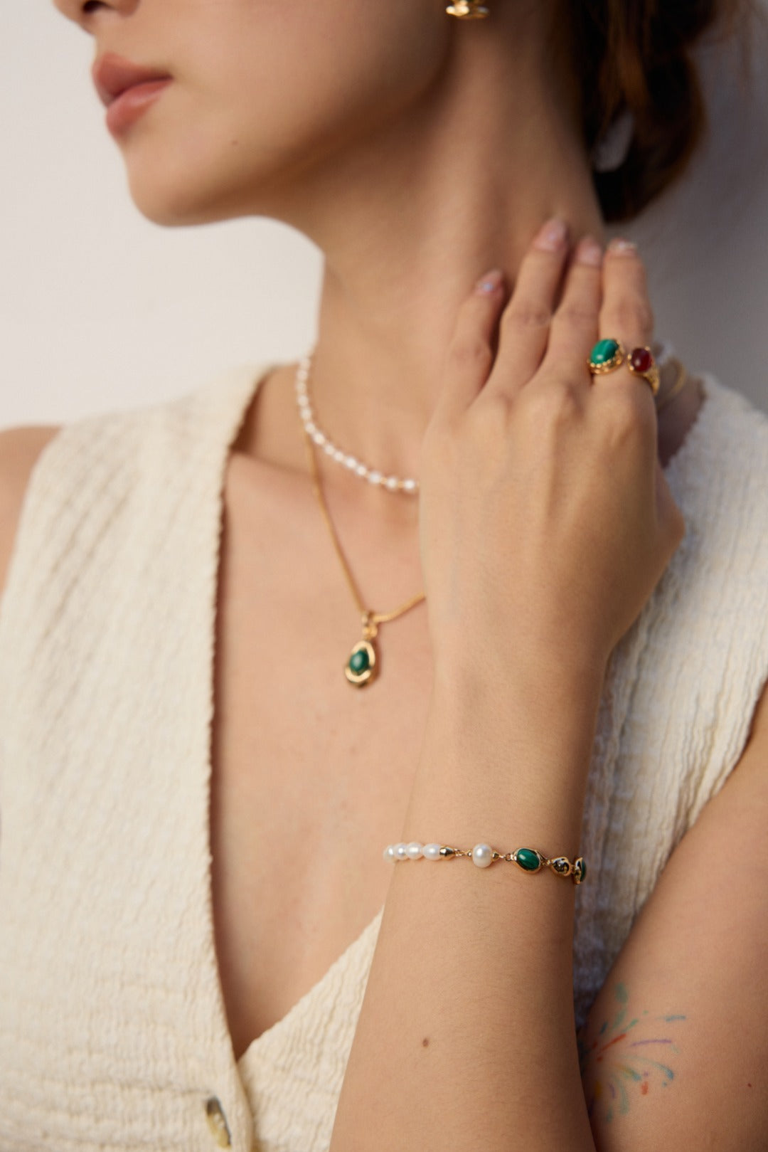 The bracelet stacked with other gold bracelets for a layered look.