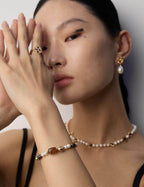 The bracelet stacked with other gold and beaded bracelets for a layered look.