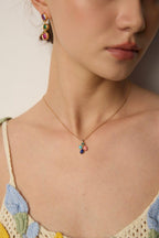 Female model wearing the vintage multi-gemstone necklace - close-up on the collarbone.