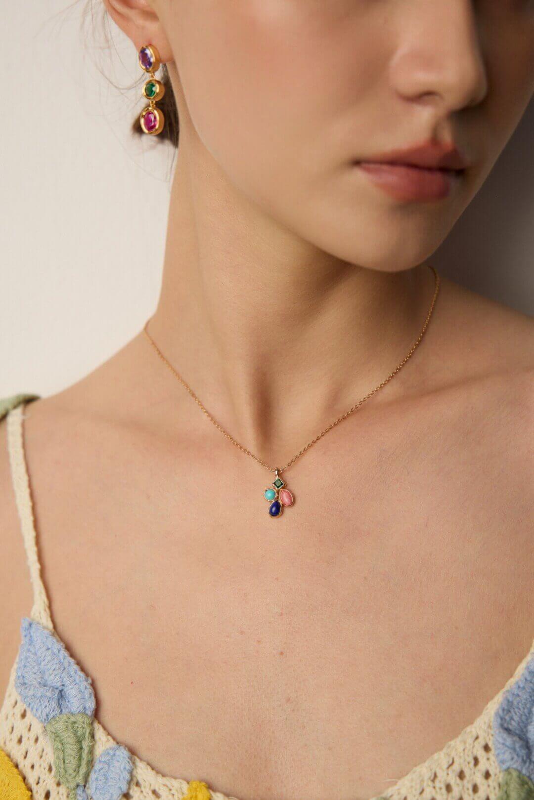 Female model wearing the vintage multi-gemstone necklace - close-up on the collarbone.