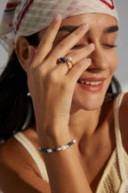 Woman wearing the lapis lazuli and baroque pearl bracelet on her wrist.