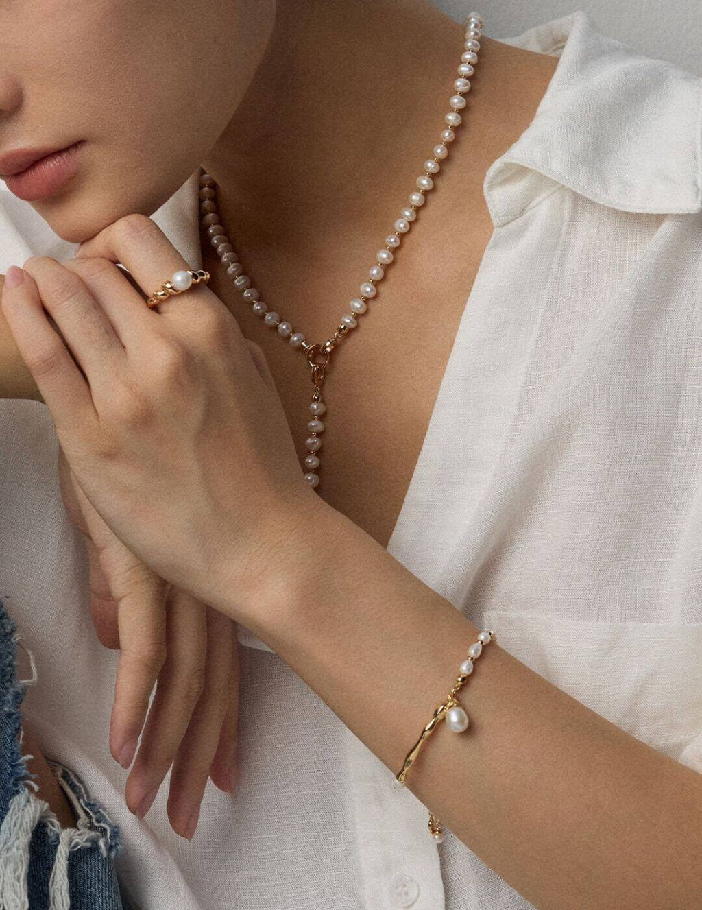 Woman wearing the natural pearl and sterling silver necklace, elegant neck close-up.