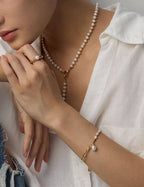 Woman wearing the natural pearl and sterling silver necklace, elegant neck close-up.