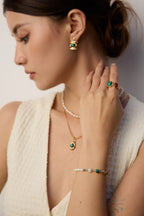 Woman wearing the natural pearl and malachite bracelet on her wrist.