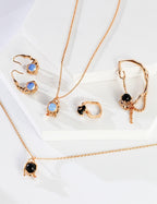Gold jewelry set with necklaces and earrings on a white background