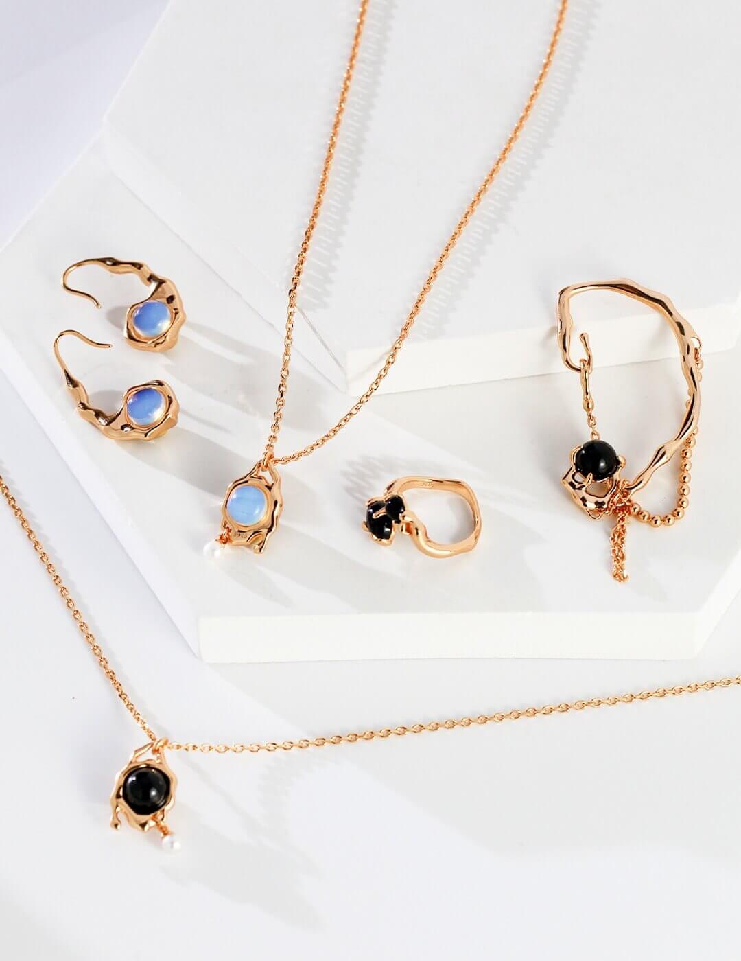Gold jewelry set with necklaces and earrings on a white background