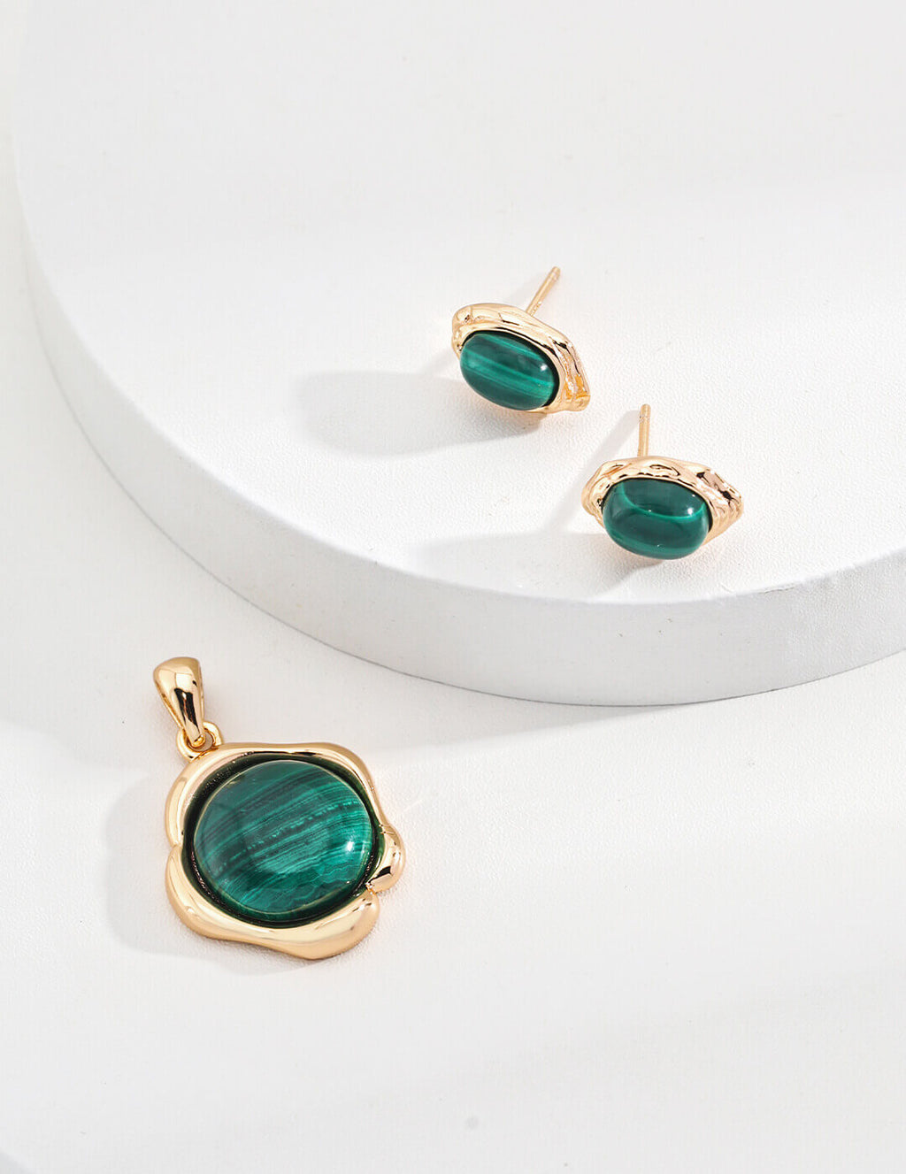 The malachite studs alongside a vintage gold necklace, styled together.