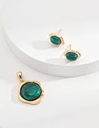 The malachite studs alongside a vintage gold necklace, styled together.