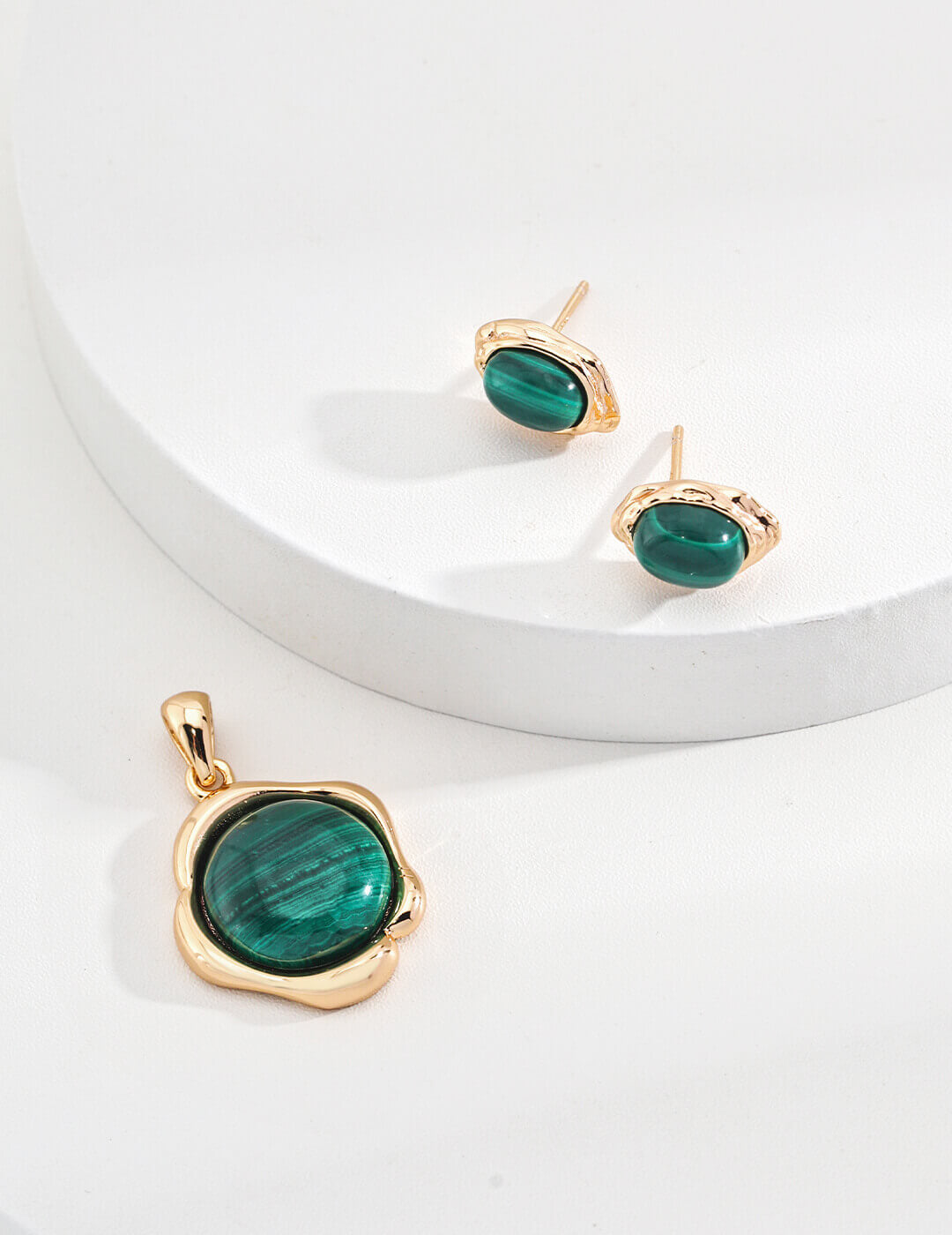 The malachite studs alongside a vintage gold necklace, styled together.