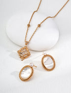 Natural pearl accent nestled against the shell and sterling silver in these minimalist earrings