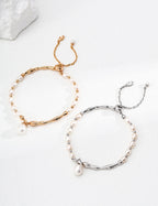 Natural pearl bracelet on a S925 sterling silver chain, isolated on a white background.