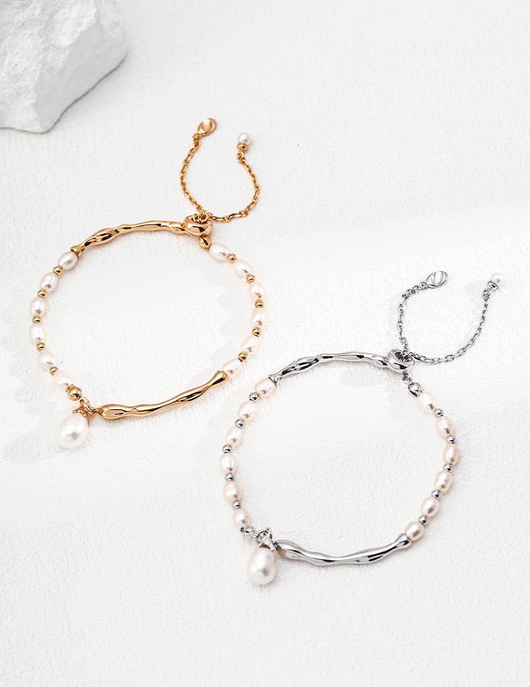 Natural pearl bracelet on a S925 sterling silver chain, isolated on a white background.