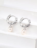 Natural pearl with soft iridescent luster, beautifully accented against the vintage wood grain texture.
