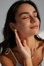 Pearl studs adding a touch of elegance to a casual daytime outfit.