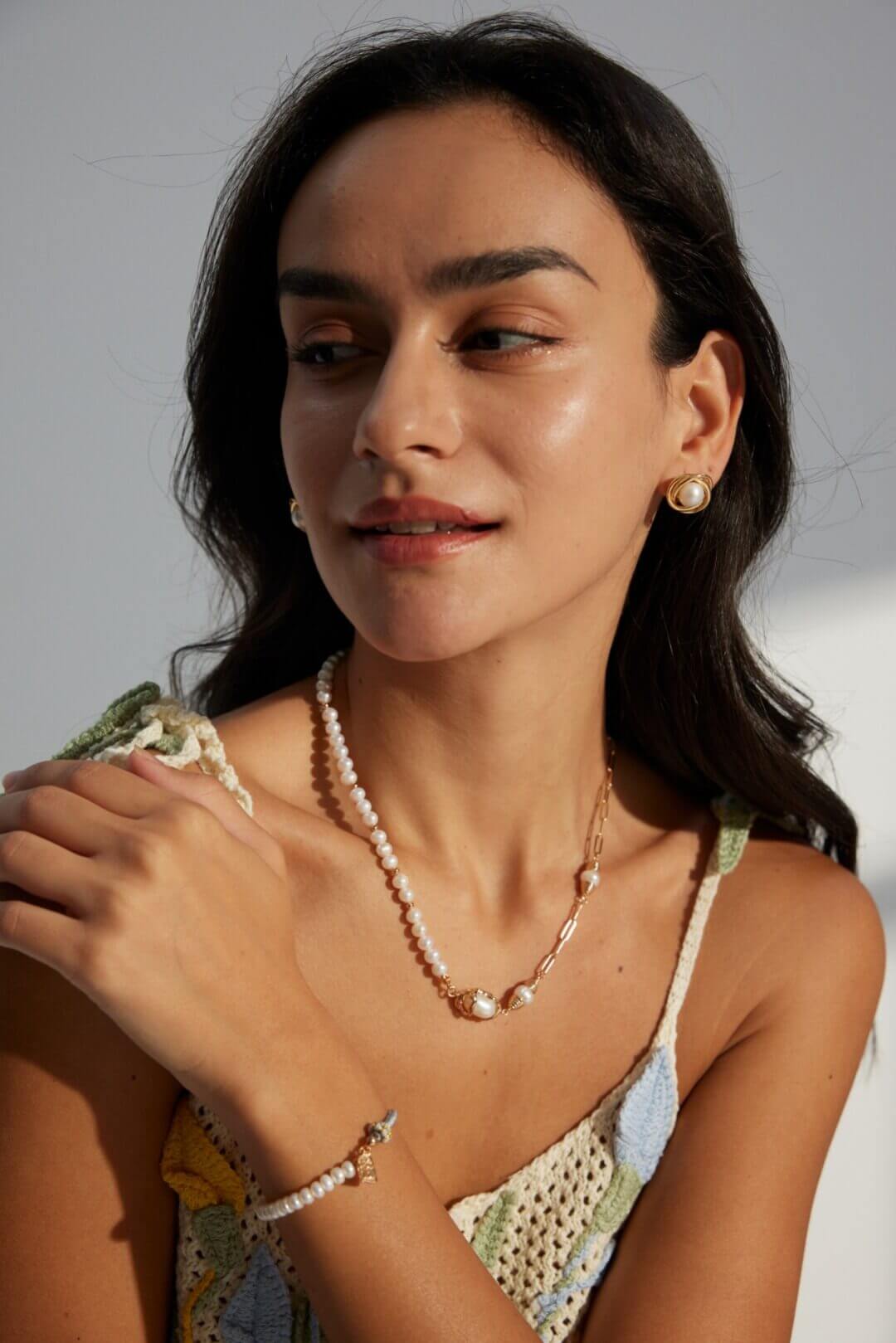 The pearl studs worn in a professional office environment.