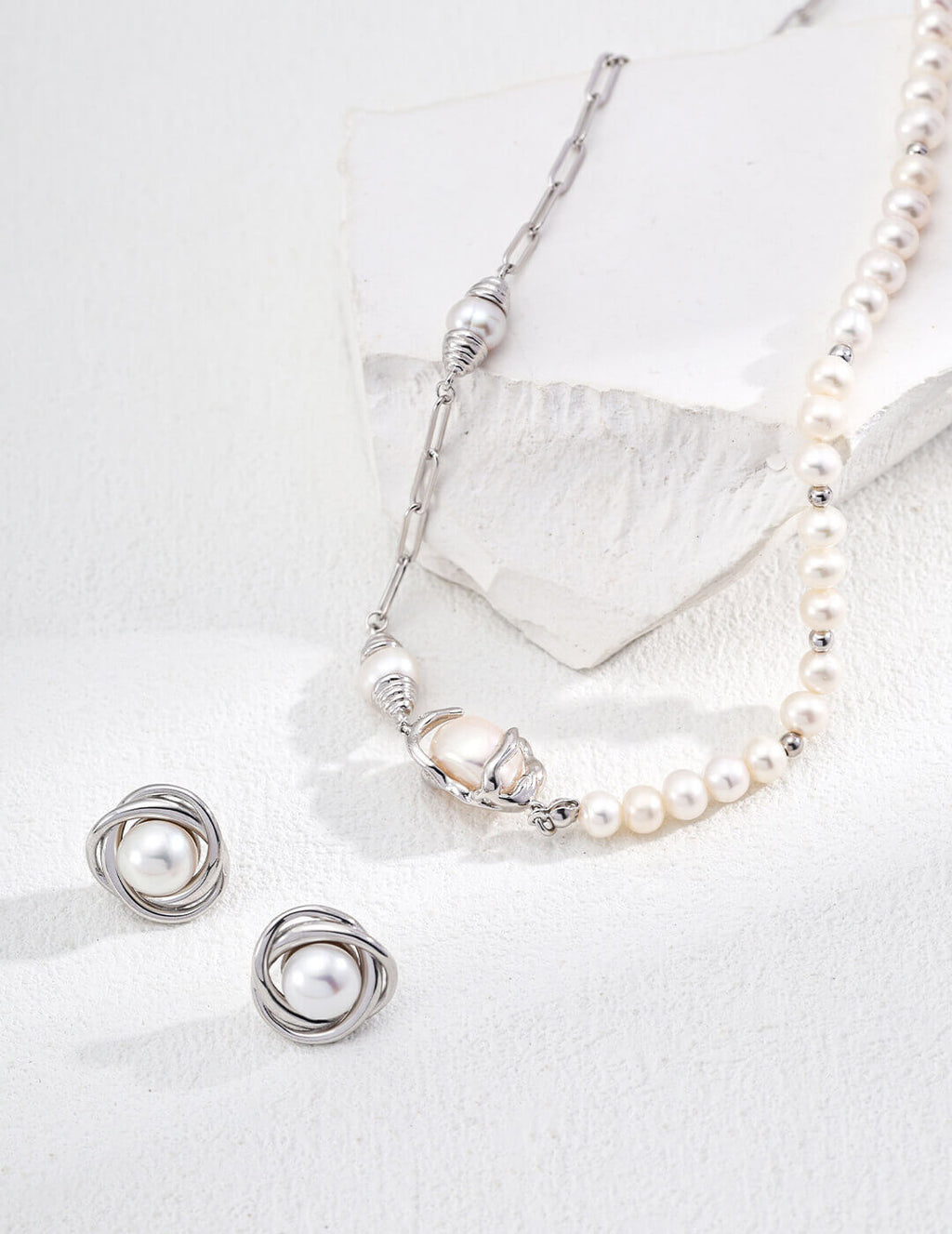 Natural pearl stud earrings in classic silver plating.