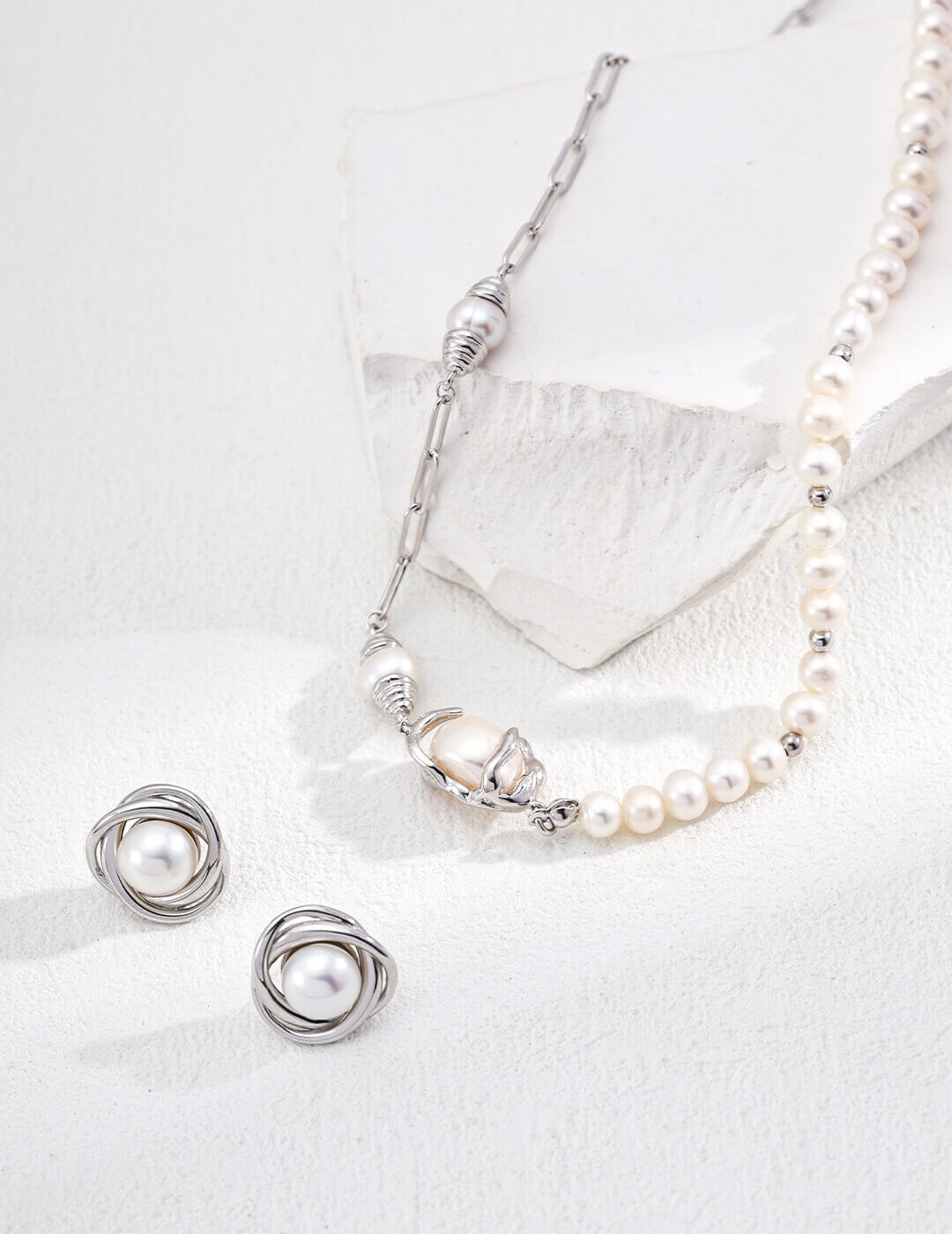Natural pearl stud earrings in classic silver plating.