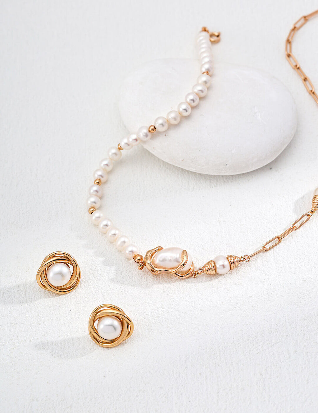 Natural pearl stud earrings plated in warm vintage gold.