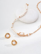 Natural pearl stud earrings plated in warm vintage gold.