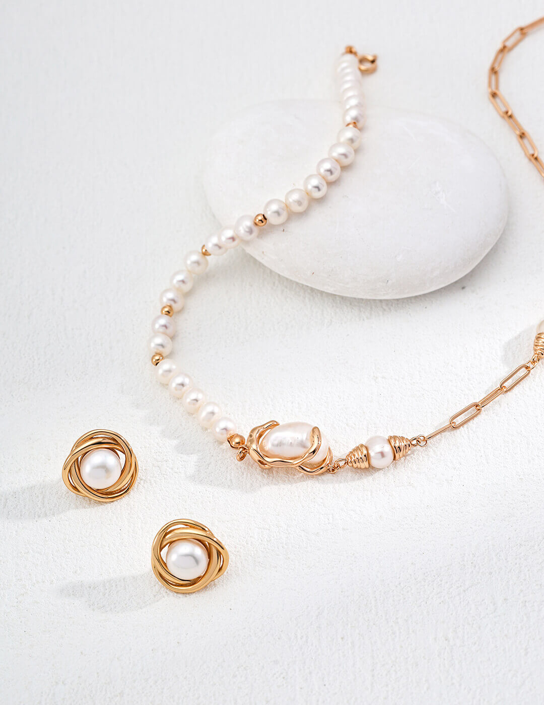 Natural pearl stud earrings plated in warm vintage gold.
