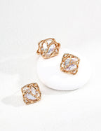 Rose gold earrings with clear gemstones on a white background