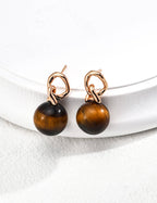 view showing secure French hook closure of tiger's eye drop earrings.