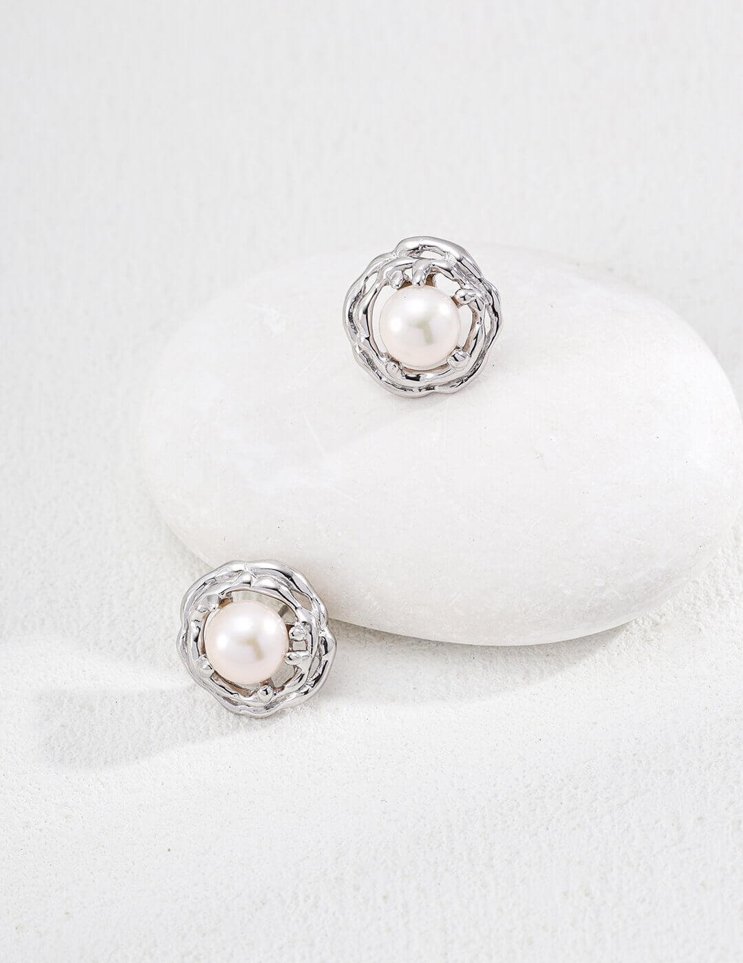 Pair of pearl earrings on a white background