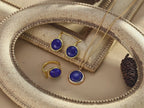 Natural Lapis Lazuli earrings catching light to showcase golden pyrite sparkle and deep blue color.