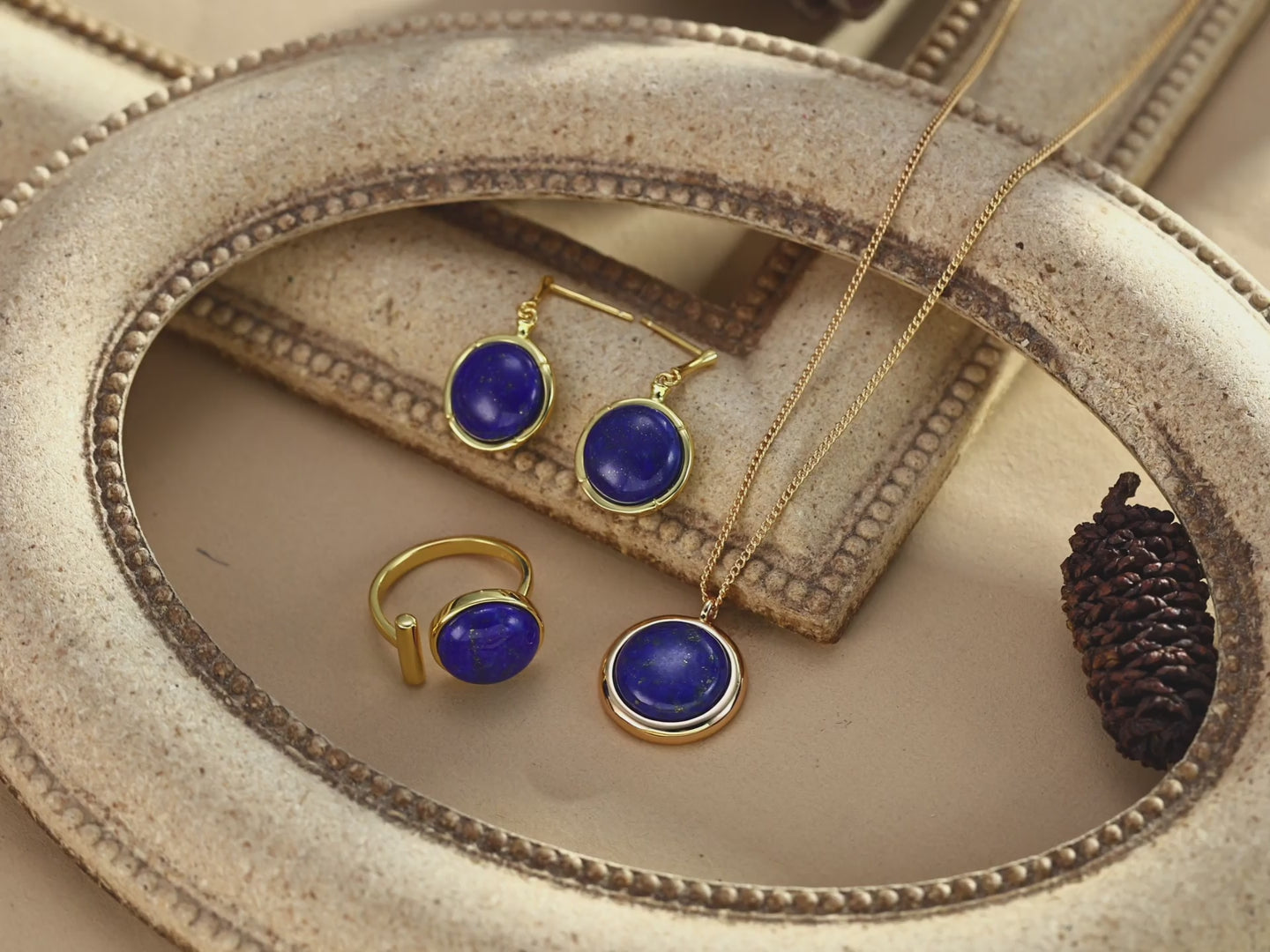 Natural Lapis Lazuli earrings catching light to showcase golden pyrite sparkle and deep blue color.