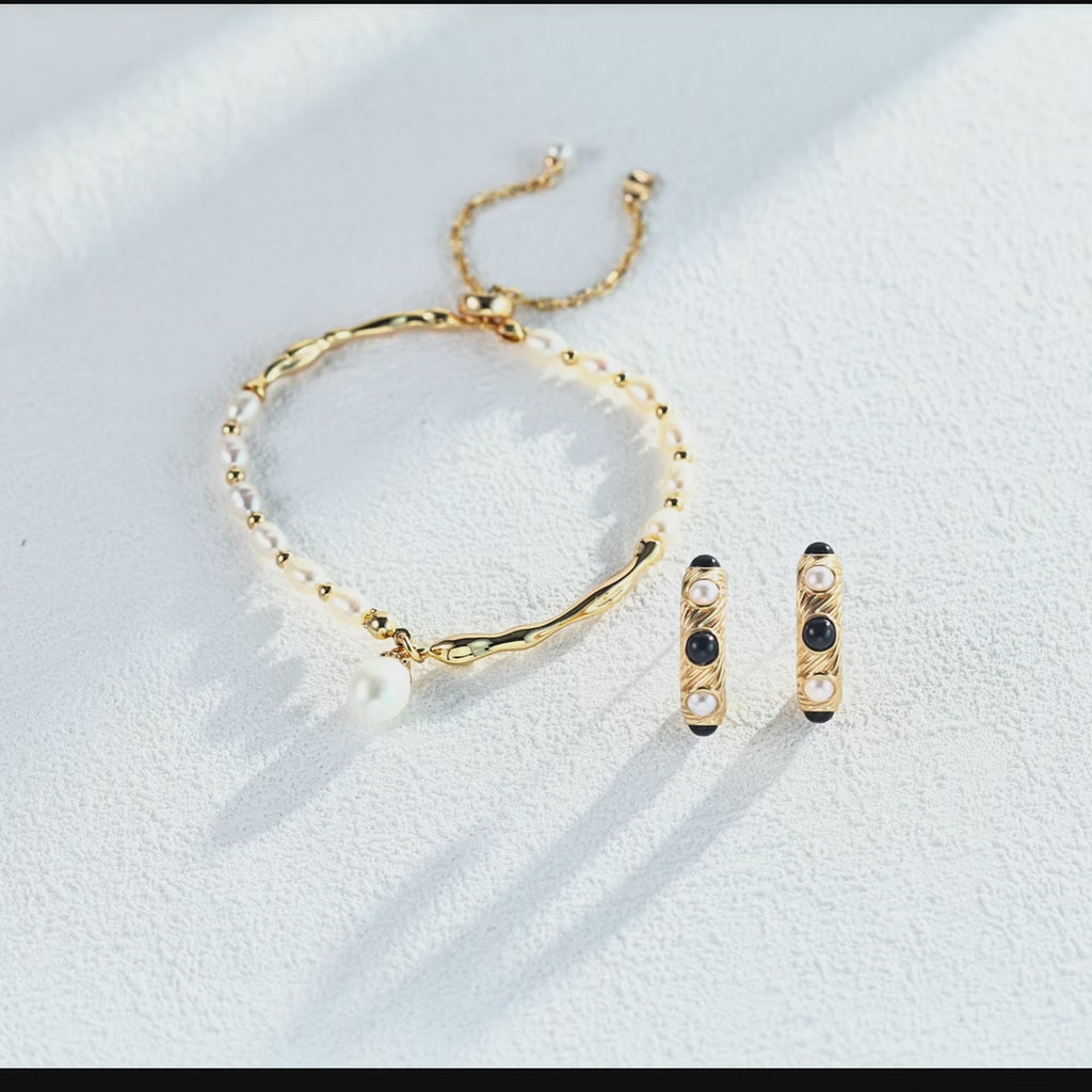 Timeless vintage pearl and onyx stud earrings in natural lifestyle setting, showcasing everyday elegance.
