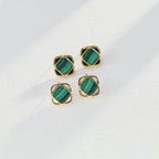 The green malachite and white shell earrings catching the light, showcasing their natural luster and fresh, vibrant colors.